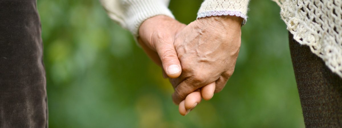 Hands,Held,Together,On,A,Natural,Green